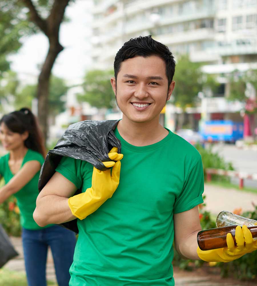 Volunteer collecting bottles during a community cleanup